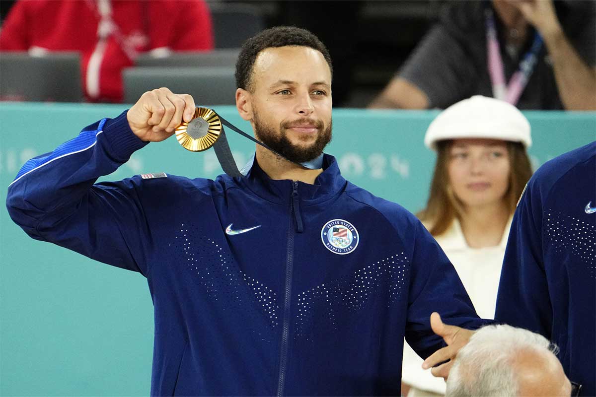 United States shooting guard Stephen Curry (4) celebrates with the gold medal after defeating France in the men's basketball gold medal game during the Paris 2024 Olympic Summer Games at Accor Arena. 