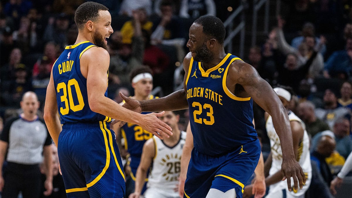 Golden State Warriors guard Stephen Curry (30) celebrates a made basket with forward Draymond Green (23) in the second half against the Indiana Pacers at Gainbridge Fieldhouse. 