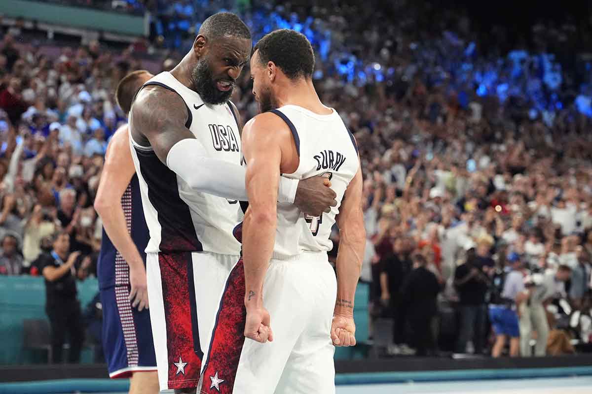 Guard LeBron James (6) and shooting guard Stephen Curry (4) of the US team celebrate after the game against Serbia in the semifinals of the men's basketball team during the 2024 Summer Olympics in Paris at the Accor Arena.