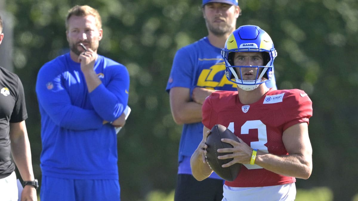 Los Angeles Rams quarterback Matthew Stafford (9) and head coach Sean McVay look on as quarterback Stetson Bennett (13) participates in drills during training camp at Loyola Marymount University.