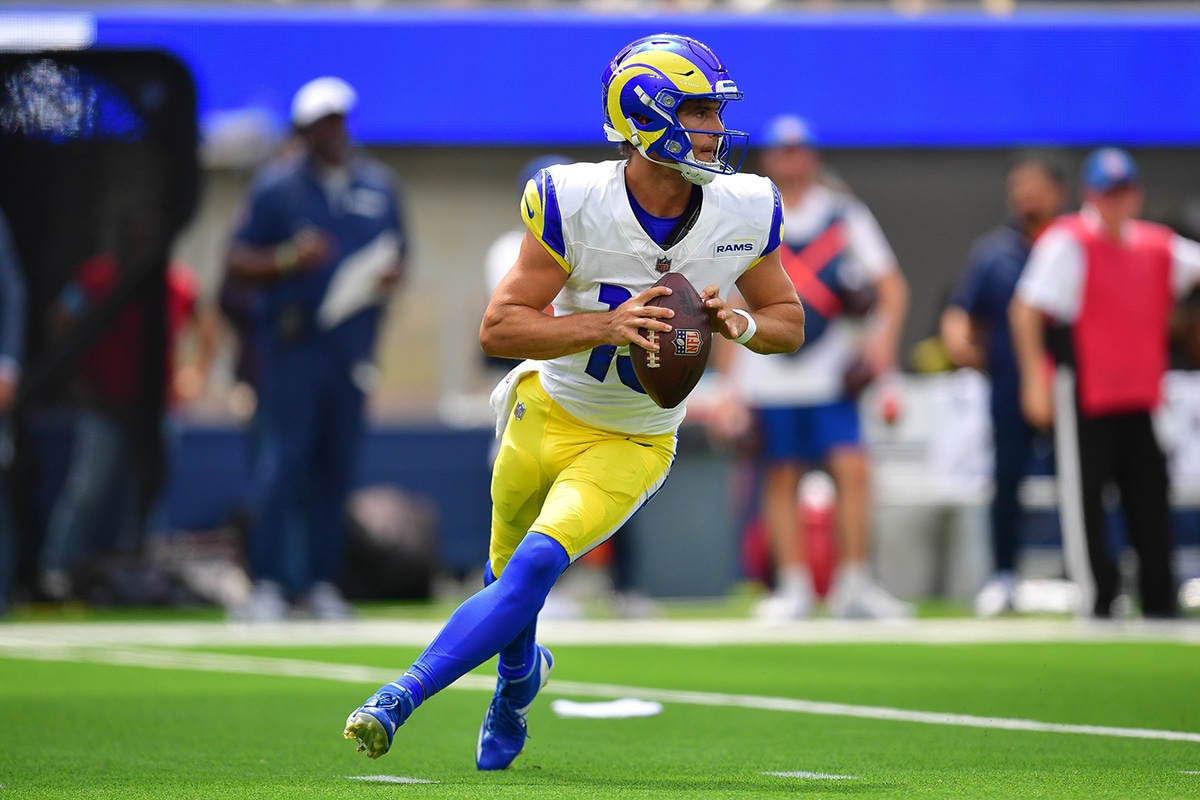 Los Angeles Rams quarterback Stetson Bennett (13) moves out to pass against the Dallas Cowboys during the first half at SoFi Stadium. 