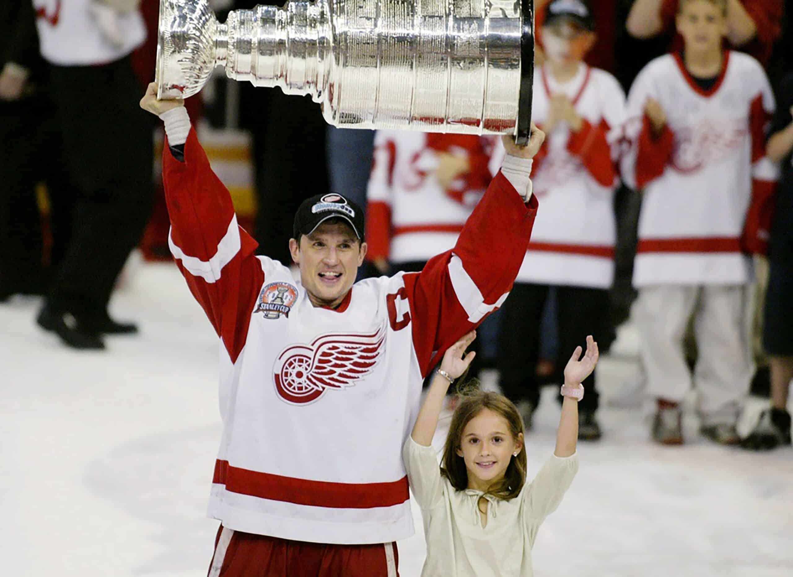 Steve Yzerman holds up the Stanley cup with his daughter Isabella after winning the cup for the third time in 2002.