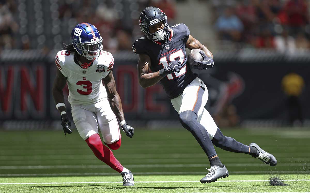 Houston Texans wide receiver Nico Collins (12) runs with the ball during the game during the game against the New York Giants at NRG Stadium.