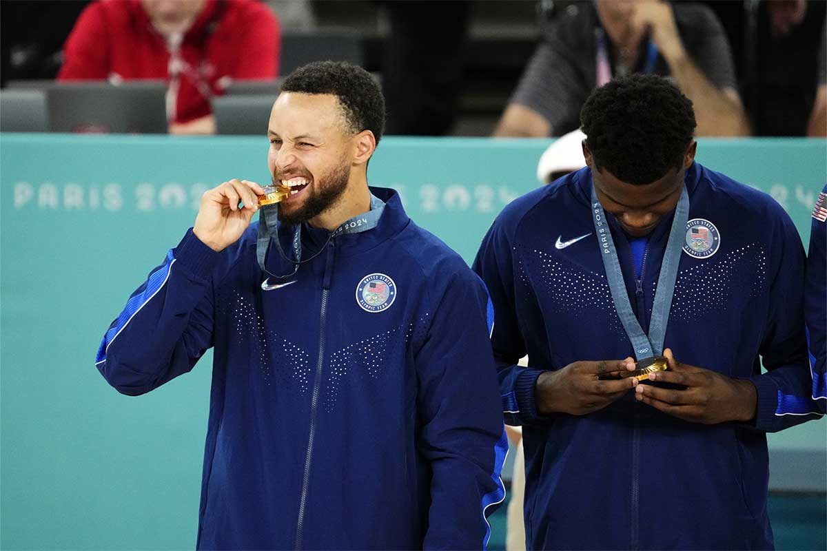 United States shooting guard Stephen Curry (4) celebrates with the gold medal after defeating France in the men's basketball gold medal game during the Paris 2024 Olympic Summer Games at Accor Arena. 