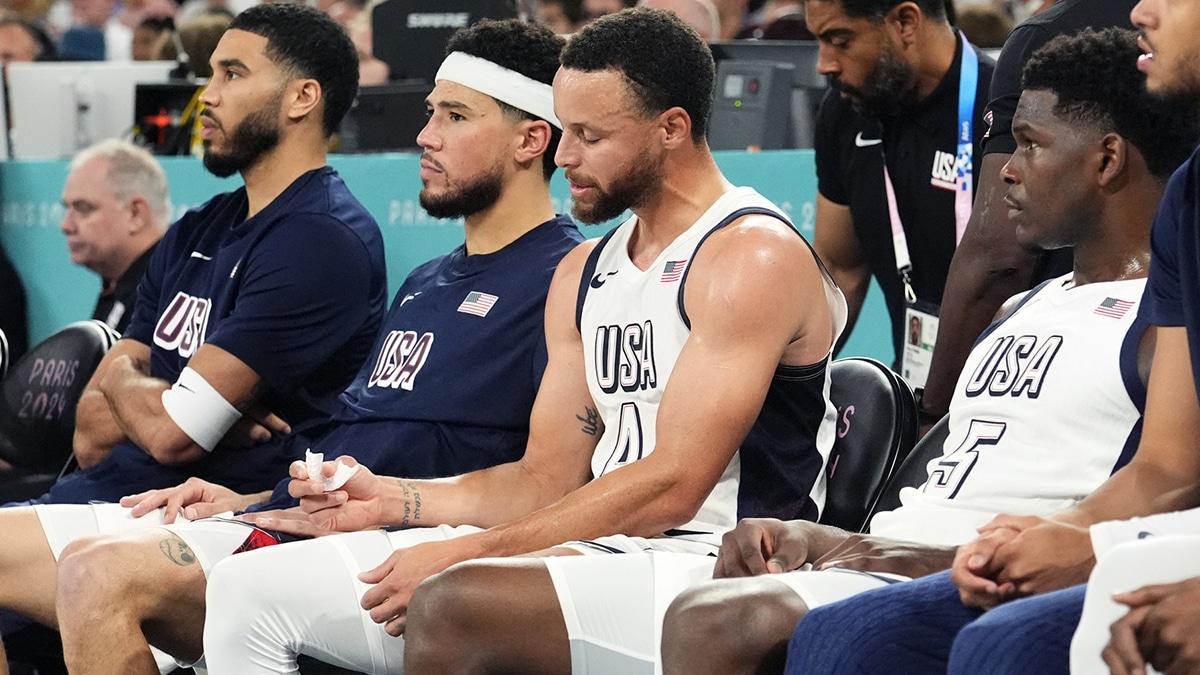  United States small forward Jayson Tatum (10), guard Devin Booker (15), shooting guard Stephen Curry (4) and guard Anthony Edwards (5) look on from the bench during the first half against Serbia in a men's basketball semifinal game during the Paris 2024 Olympic Summer Games at Accor Arena. 