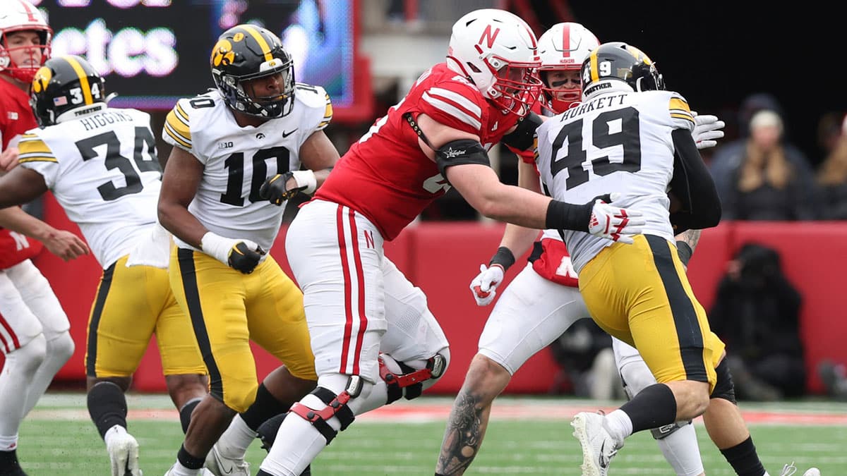 Iowa Hawkeyes defensive lineman Ethan Hurkett (49) is tackled by Nebraska Cornhuskers offensive lineman Teddy Prochazka (65) after an interception by Hurkett at Memorial Stadium.