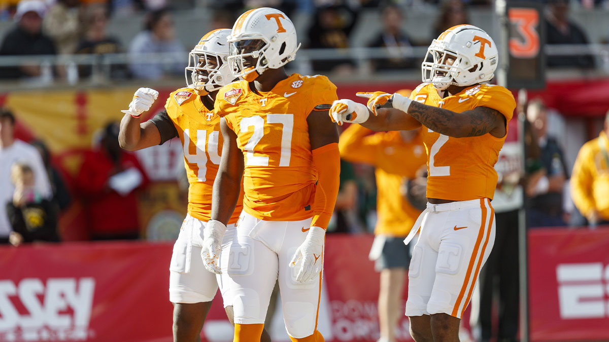 Tennessee Volunteers defensive lineman James Pearce Jr. (27), linebacker Elijah Herring (44) and defensive back Jaylen McCollough (2) celebrate a sack against the Iowa Hawkeyes during the third quarter at Camping World Stadium.