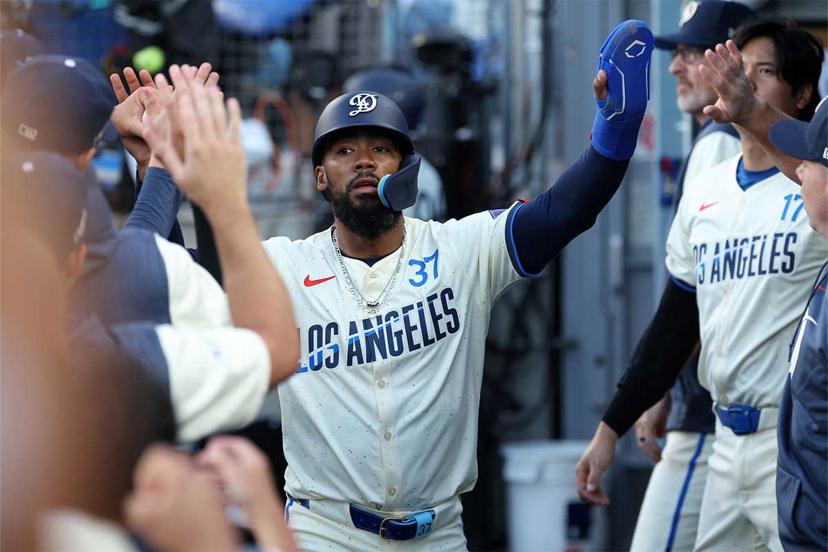 Los Angeles Dodgers left fielder Teoscar Hernandez (37) is greeted in the dugout after scoring a run during the first inning against the Pittsburgh Pirates at Dodger Stadium. 