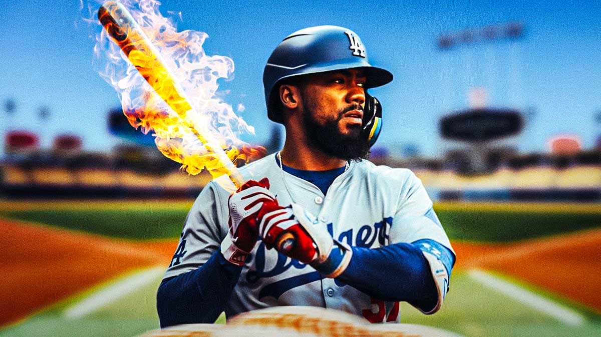 Teoscar Hernandez holding a flaming bat in front of Dodger Stadium