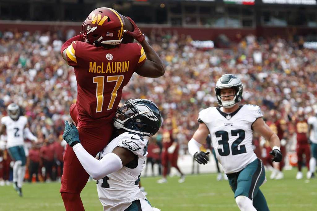Washington Commanders wide receiver Terry McLaurin (17) catches a touchdown pass as Philadelphia Eagles cornerback James Bradberry (24) defends during the first quarter at FedExField.