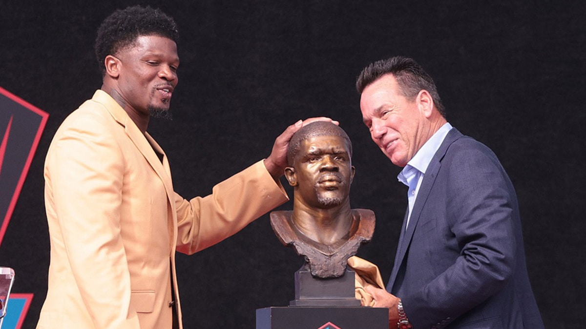 Andre Johnson and his former Houston Texans coach Gary Kubiak admire his bust at the 2024 Pro Football Hall of Fame Enshrinement at Tom Benson Hall of Fame Stadium