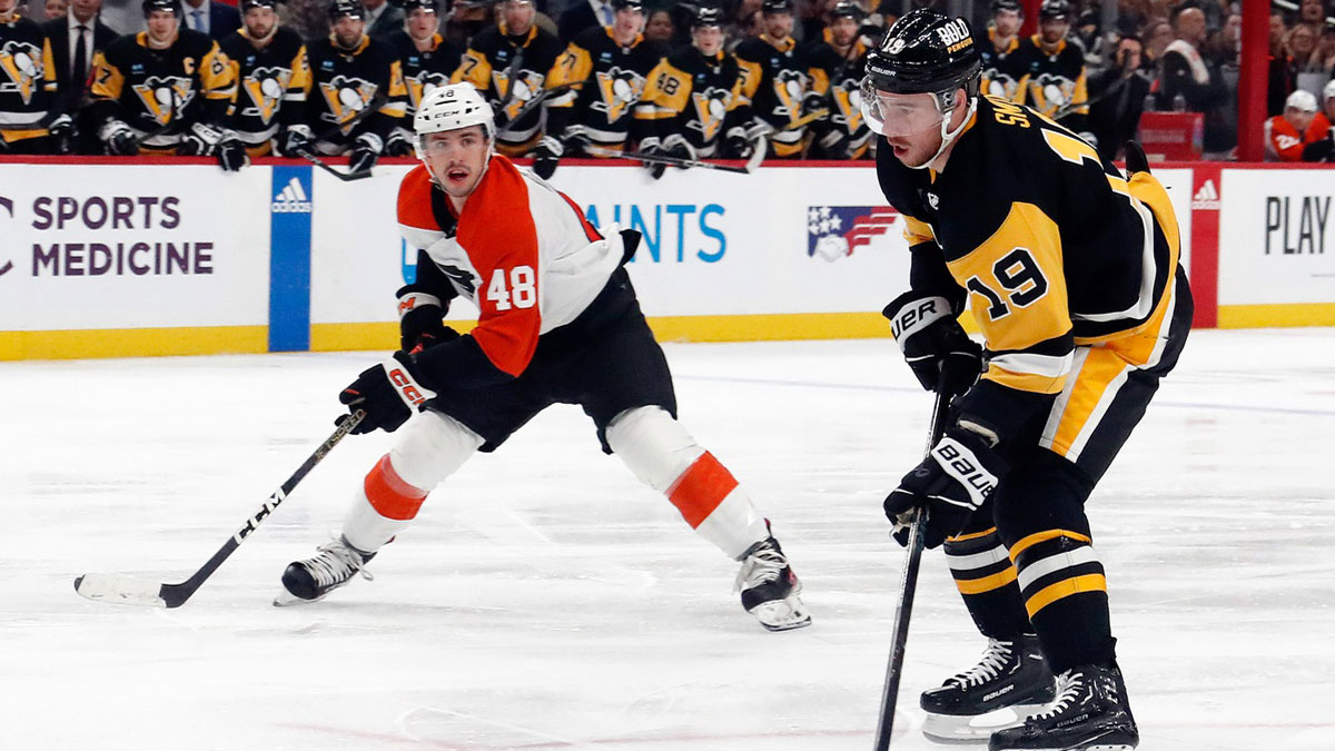 Pittsburgh Penguins right wing Reilly Smith (19) skates with the puck against Philadelphia Flyers center Morgan Frost (48) during the second period at PPG Paints Arena.