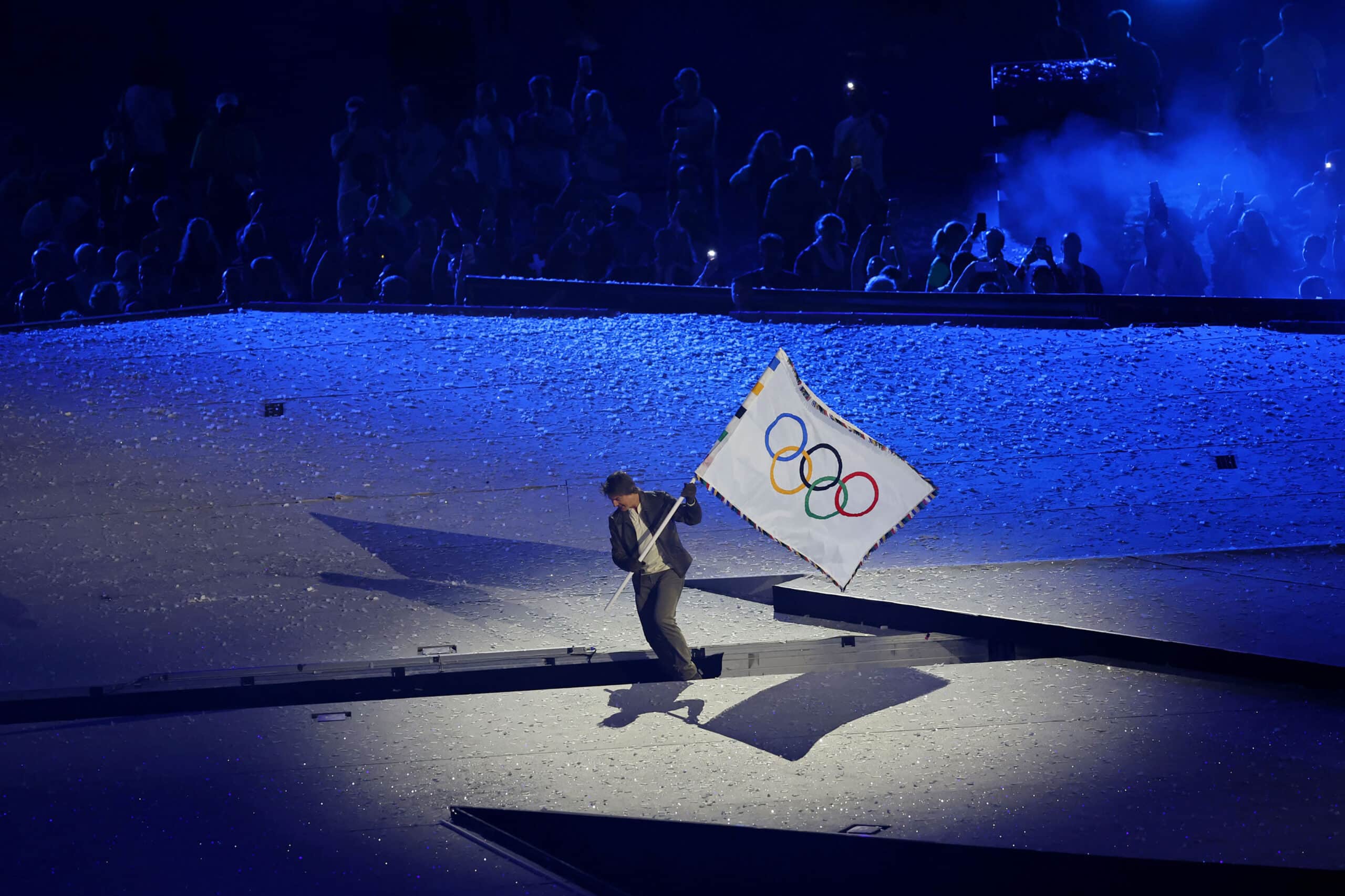 Aug 11, 2024; Saint-Denis, France; Tom Cruise carries the Olympic flag during the closing ceremony for the Paris 2024 Olympic Summer Games at Stade de France. Mandatory Credit: Yukihito Taguchi-USA TODAY Sports