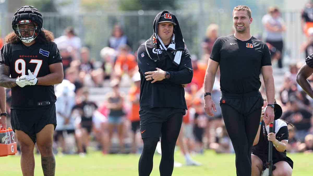 Cincinnati Bengals defensive end Trey Hendrickson (91) and defensive end Sam Hubbard (94) observe play during training camp practice at Kettering Health Practice Fields. 