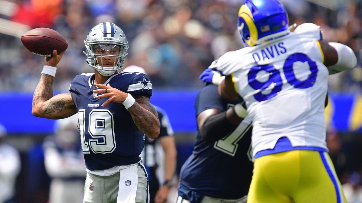 Dallas Cowboys quarterback Trey Lance (19) throws under pressire from Los Angeles Rams defensive tackle Tyler Davis (90) during the first half at SoFi Stadium