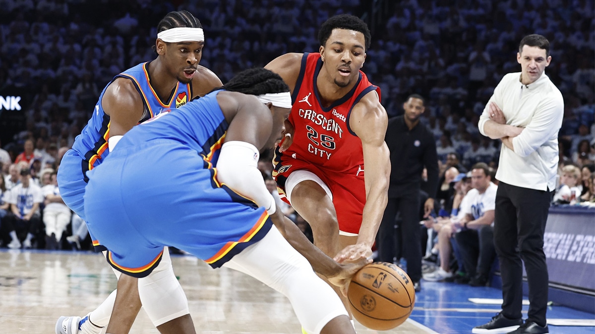 New Orleans Pelicans guard Trey Murphy III (25) and Oklahoma City Thunder guard Luguentz Dort (5) reach for a loose ball during the second quarter of game two of the first round for the 2024 NBA playoffs at Paycom Center. 