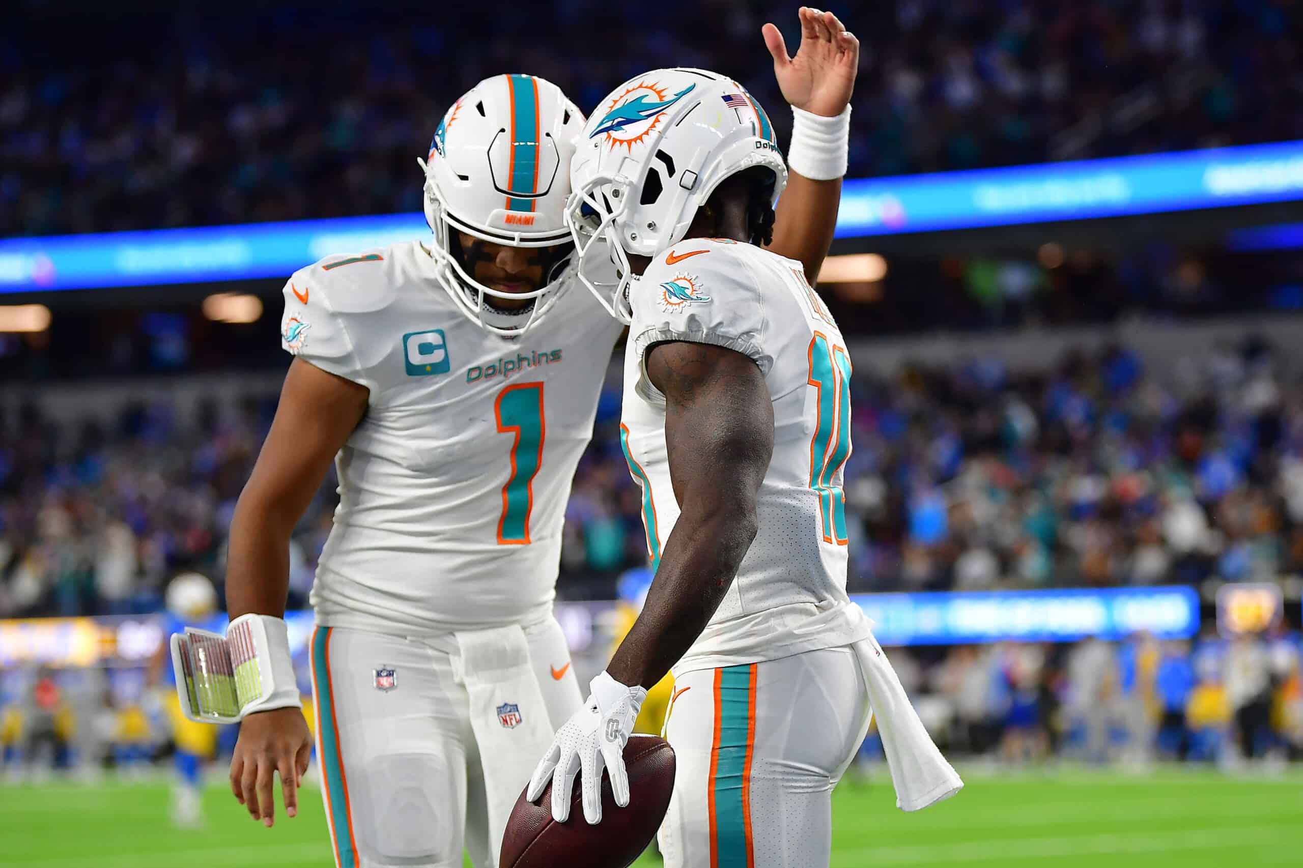 Miami Dolphins wide receiver Tyreek Hill (10) celebrates his touchdown scored against the Los Angeles Chargers with quarterback Tua Tagovailoa (1) during the first half at SoFi Stadium. 