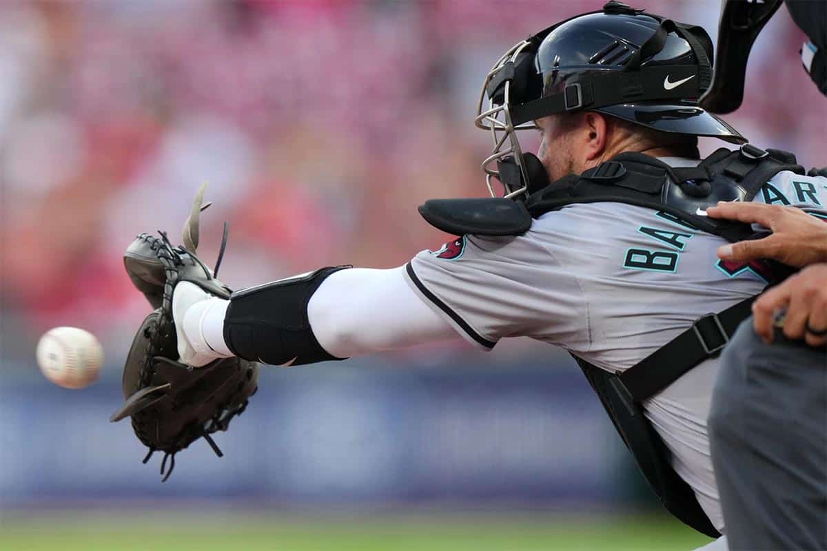 Arizona Diamondbacks catcher Tucker Barnhart (16) receives a pitch in the first inning of a baseball game between the Arizona Diamondbacks and Cincinnati Reds, Tuesday, May 7, 2024, at Great American Ball Park in Cincinnati.