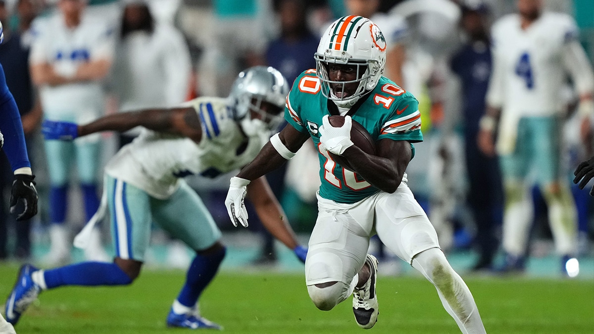 Miami Dolphins wide receiver Tyreek Hill (10) runs with the ball after a catch during the second half against the Dallas Cowboys at Hard Rock Stadium.