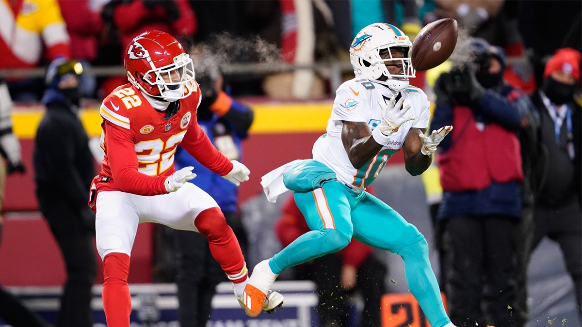 Miami Dolphins wide receiver Tyreek Hill (10) catches a pass ahead of Kansas City Chiefs cornerback Trent McDuffie (22) during the first half of the 2024 AFC wild card game at GEHA Field at Arrowhead Stadium. 