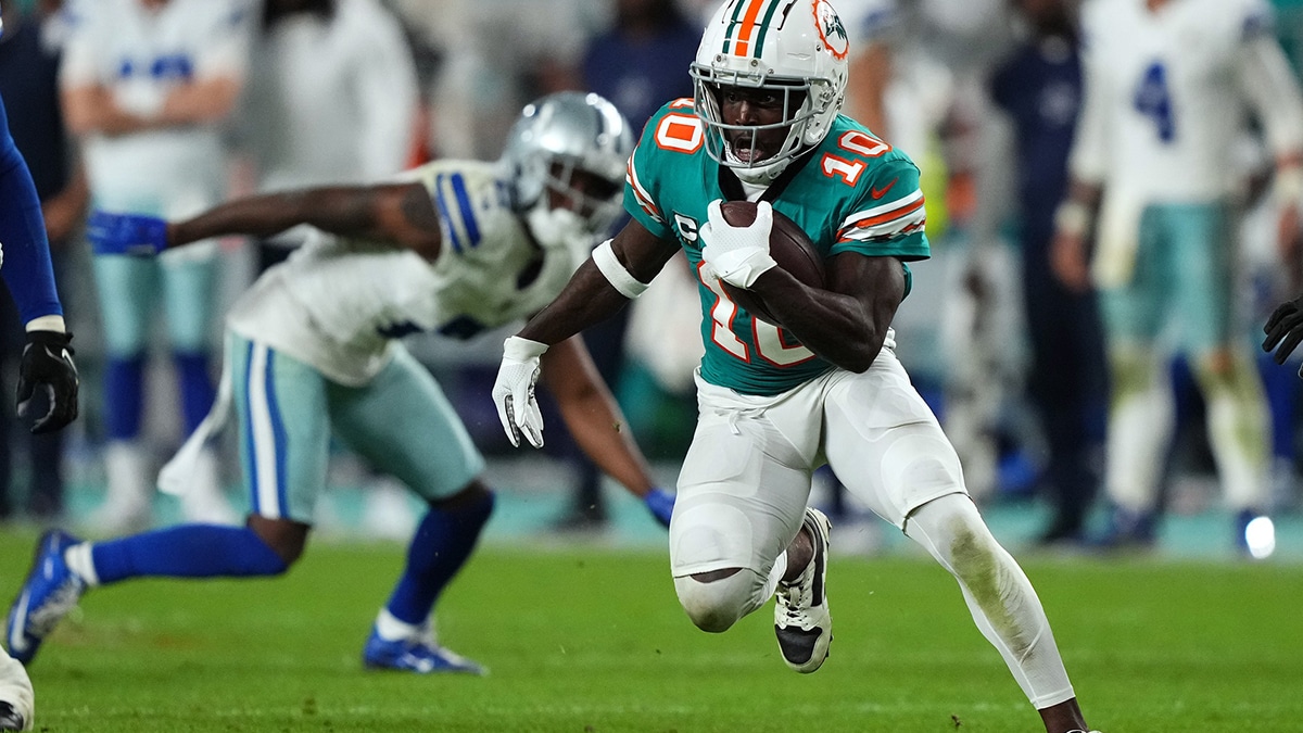 Miami Dolphins wide receiver Tyreek Hill (10) runs with the ball after a catch during the second half against the Dallas Cowboys at Hard Rock Stadium. 