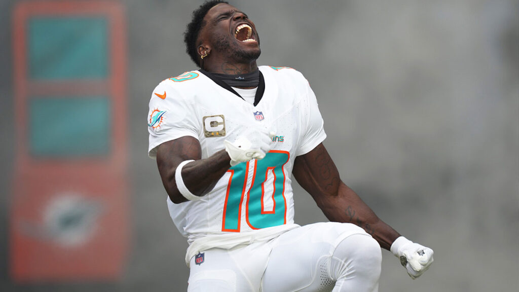 Miami Dolphins wide receiver Tyreek Hill (10) runs onto the field during pregame ceremonies of an NFL game against the Las Vegas Raiders at Hard Rock Stadium in Miami Gardens, Nov. 19, 2023.