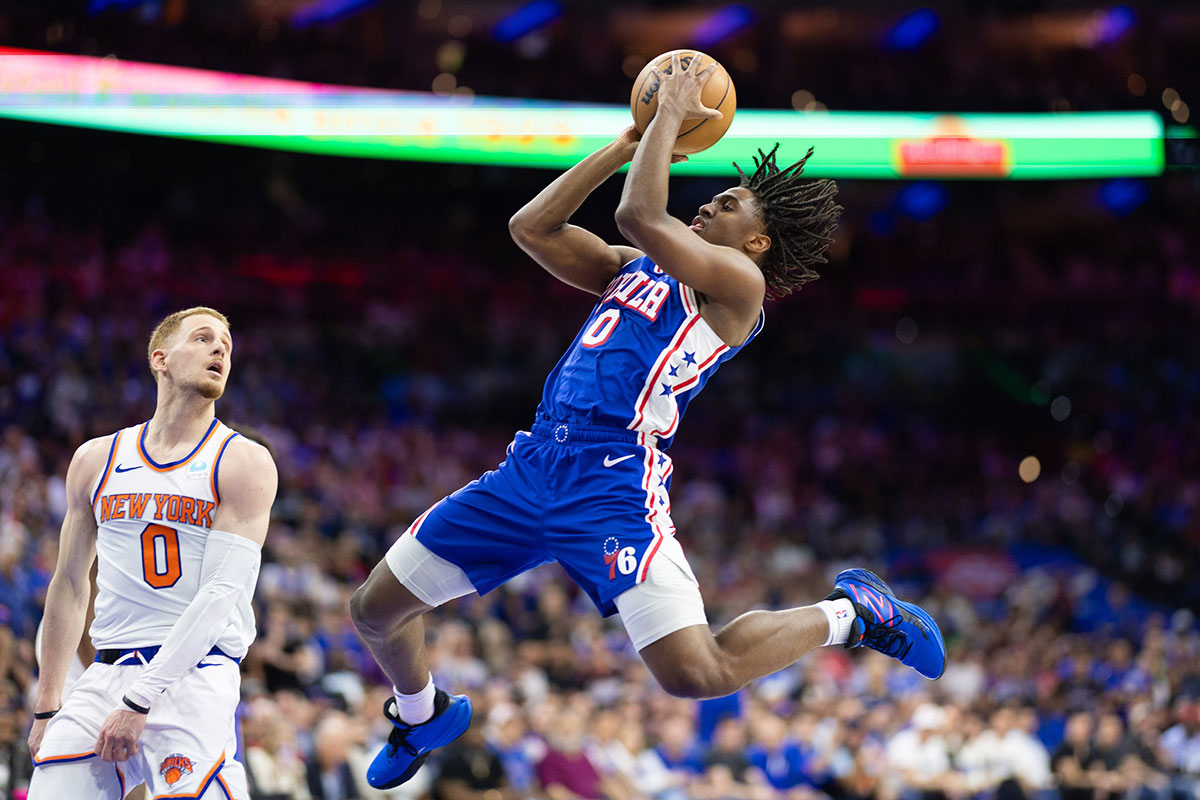 Philadelphia 76ers guard Tyrese Maxey (0) drives for a shot in front of New York Knicks guard Donte DiVincenzo (0) during game six of the first round for the 2024 NBA playoffs at Wells Fargo Center.
