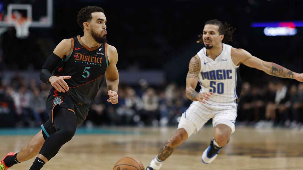 Washington Wizards guard Tyus Jones (5) drives to the basket as Orlando Magic guard Cole Anthony (50) defends in the fourth quarter at Capital One Arena. 