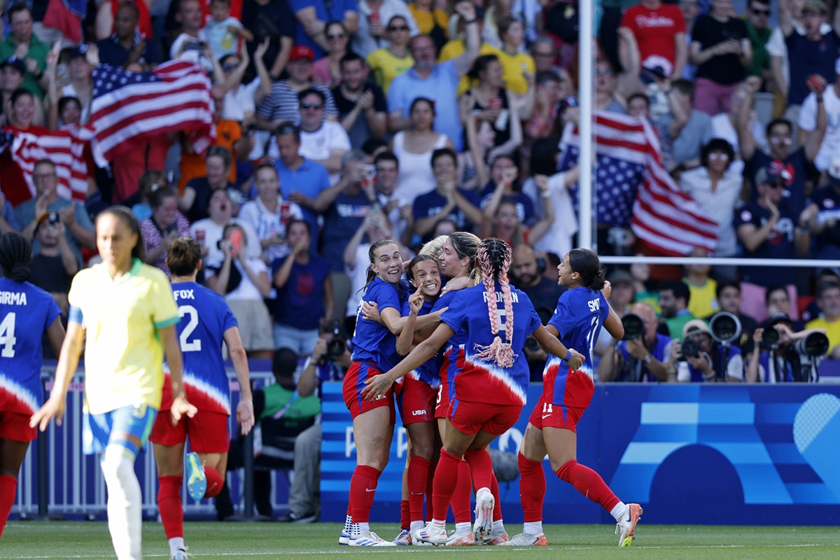 United States forward Mallory Swanson (9) celebrates her goal against Brazil with teammates during the second half in the women's soccer gold medal match during the Paris 2024 Olympic Summer Games at Parc des Princes. 