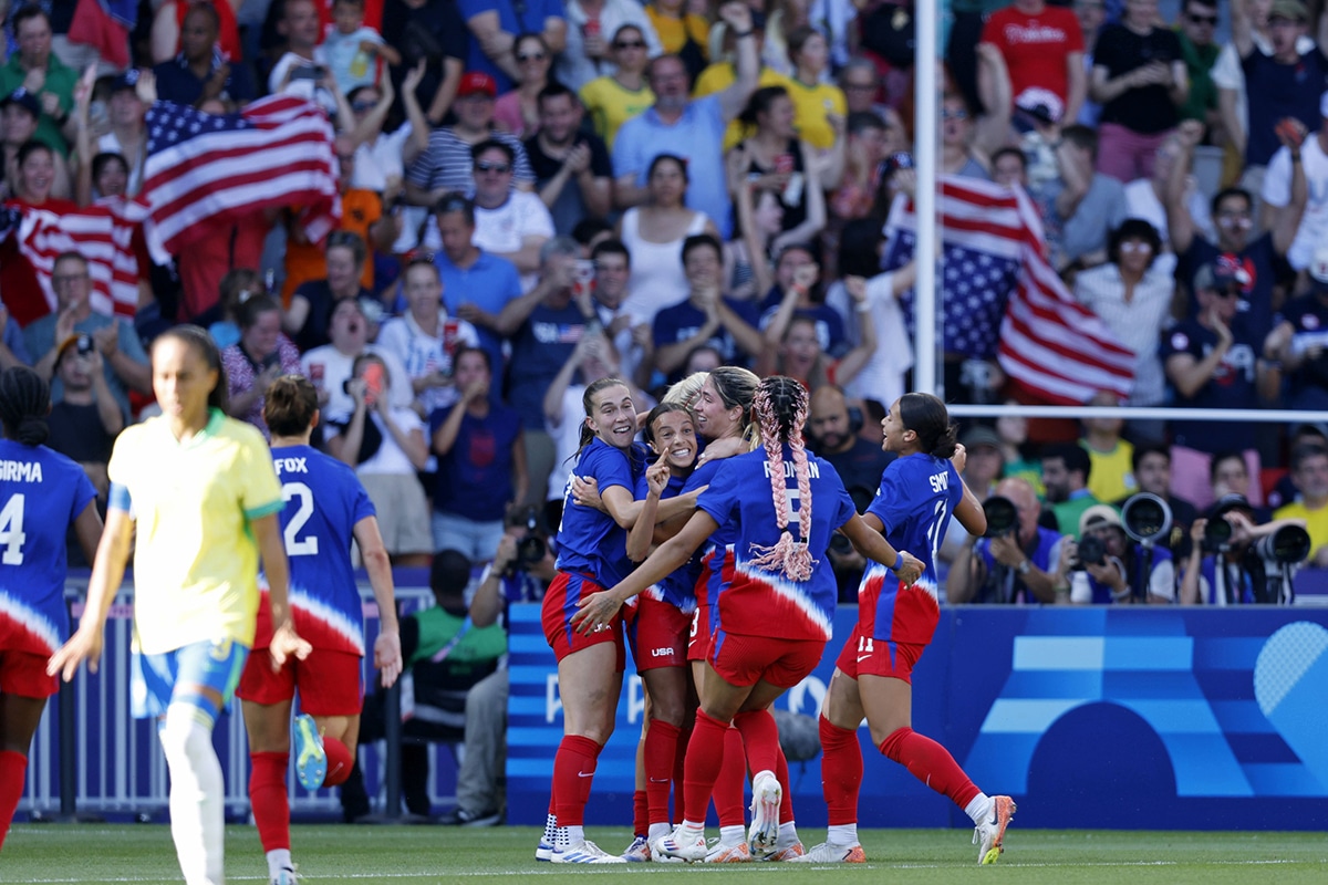 United States forward Mallory Swanson (9) celebrates her goal against Brazil with teammates during the second half in the women's soccer gold medal match during the Paris 2024 Olympic Summer Games at Parc des Princes.