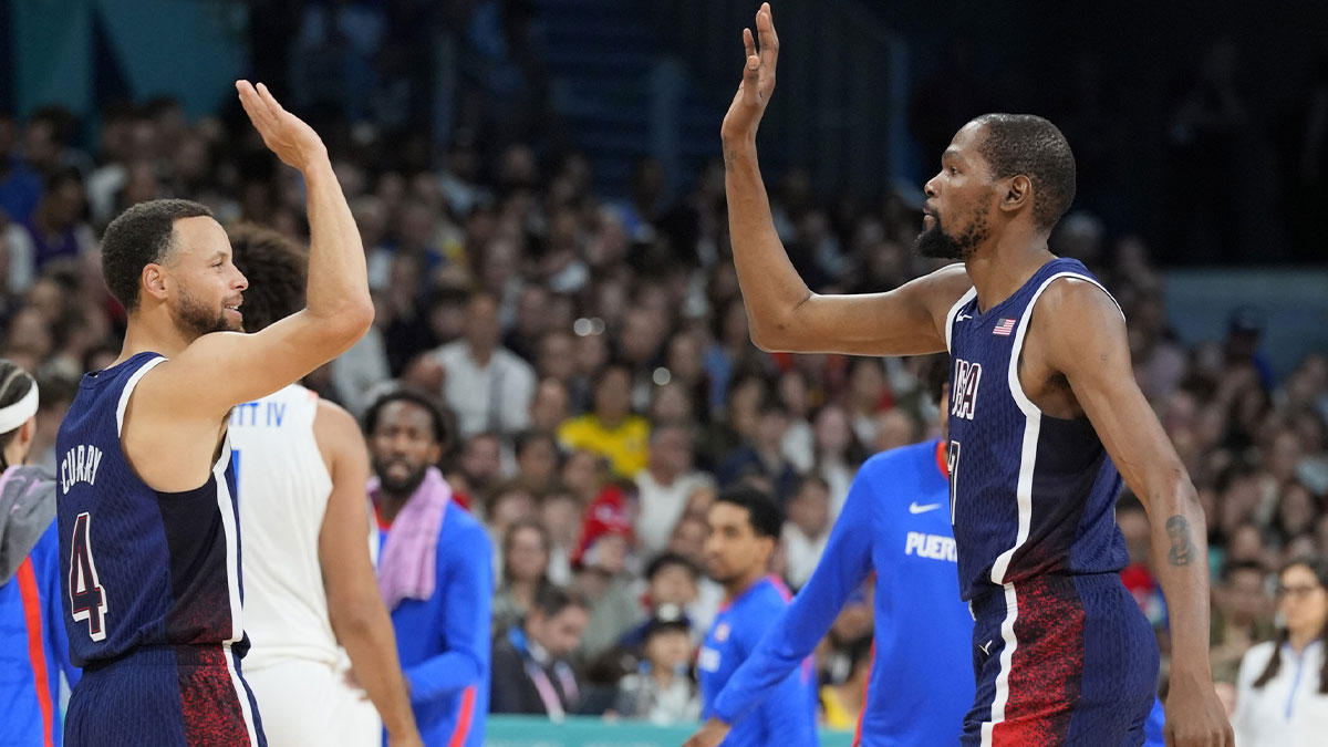 Aug 3, 2024; Villeneuve-d'Ascq, France; United States guard Kevin Durant (7) celebrates with shooting guard Stephen Curry (4) in the second quarter against Puerto Rico during the Paris 2024 Olympic Summer Games at Stade Pierre-Mauroy. Mandatory Credit: John David Mercer-USA TODAY Sports