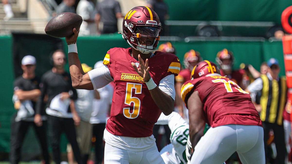 Washington Commanders quarterback Jayden Daniels (5) throws the ball during the first quarter against the New York Jets at MetLife Stadium.