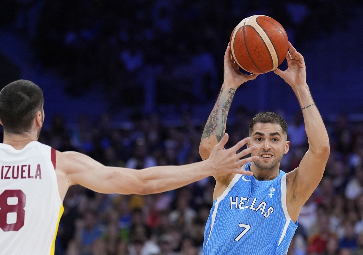 Greece guard Vasileios Toliopoulos (7) is defended by Spain shooting guard Dario Brizuela (8) in a men's basketball group stage match during the Paris 2024 Olympic Summer Games at Stade Pierre-Mauroy.