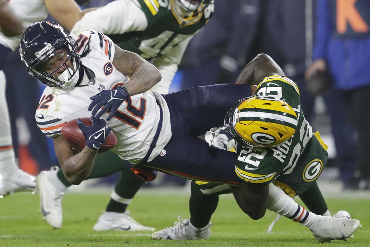 Green Bay Packers cornerback Robert Rochell (22) tackles Chicago Bears wide receiver Velus Jones Jr. (12) at the ten yard line on a kick off return during their football game at Lambeau Field.