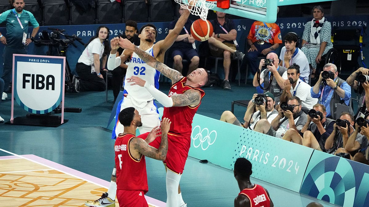 France power forward Victor Wembanyama (32) dunks the ball over Germany power forward Daniel Theis (10) during the first half in a men's basketball semifinal game during the Paris 2024 Olympic Summer Games at Accor Arena. 