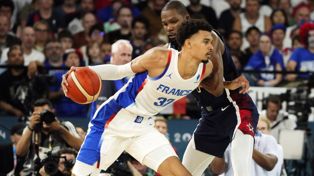  France power forward Victor Wembanyama (32) controls the ball against United States guard Kevin Durant (7) in the second half in the men's basketball gold medal game during the Paris 2024 Olympic Summer Games at Accor Arena. 