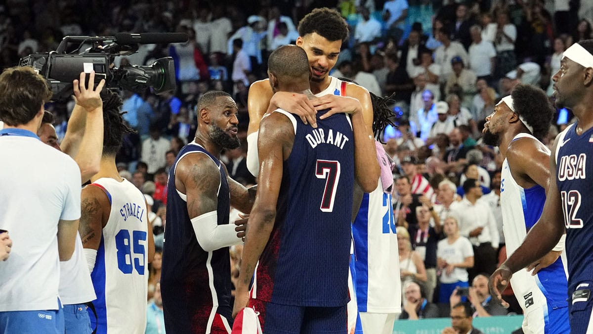 United States guard Kevin Durant (7) embraces France power forward and Spurs star Victor Wembanyama (32) after the men's basketball gold medal game during the Paris 2024 Olympic Summer Games at Accor Arena.