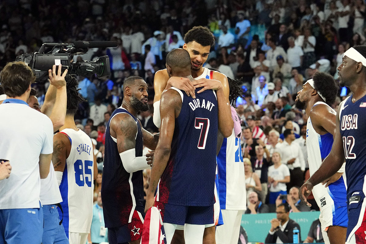 United States guard Kevin Durant (7) embraces France power forward Victor Wembanyama (32) after the men's basketball gold medal game during the Paris 2024 Olympic Summer Games at Accor Arena. Rob Schumacher-USA TODAY Sports