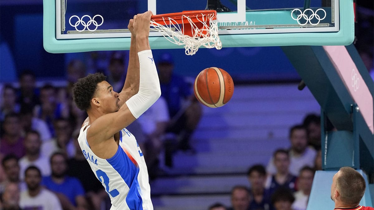 France power forward Victor Wembanyama (32) dunks against Germany in the first half in a men’s group B basketball game during the Paris 2024 Olympic Summer Games at Stade Pierre-Mauroy.