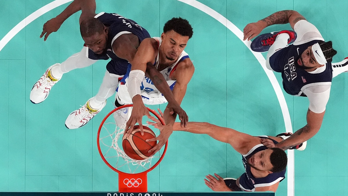 Aug 10, 2024; Paris, France; France power forward Victor Wembanyama (32) shoots against United States guard Kevin Durant (7) and shooting guard Stephen Curry (4) in the second half in the men's basketball gold medal game during the Paris 2024 Olympic Summer Games at Accor Arena. Mandatory Credit: Kyle Terada-USA TODAY Sports