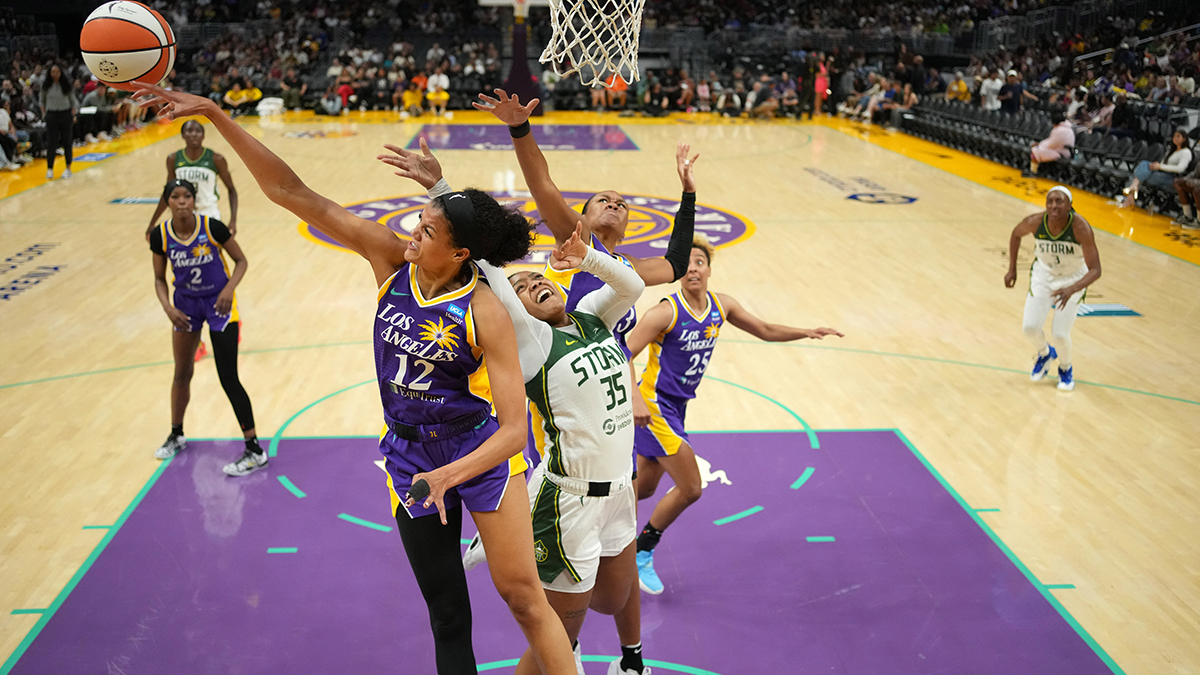 LA Sparks guard Rae Burrell (12) blocks a shot by Seattle Storm guard Victoria Vivians (35) in the first half at Crypto.com Arena.
