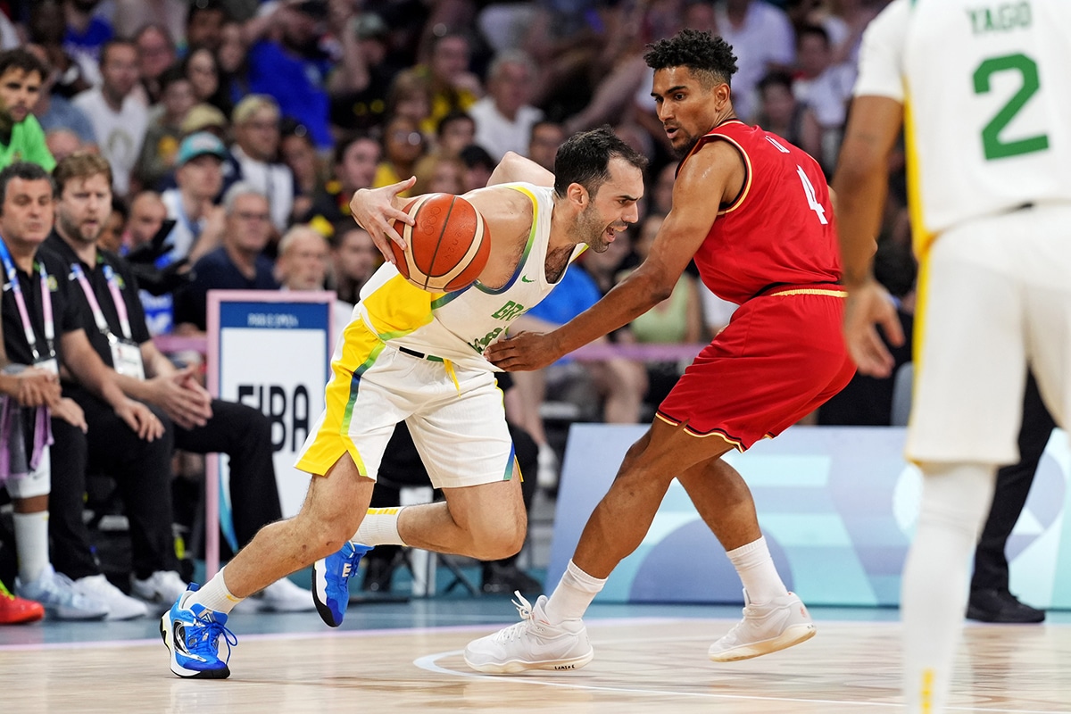 Brazil shooting guard Vitor Benite (8) drives to the basket against Germany point guard Maodo Lo (4) in men’s basketball group B play during the Paris 2024 Olympic Summer Games at Stade Pierre-Mauroy.