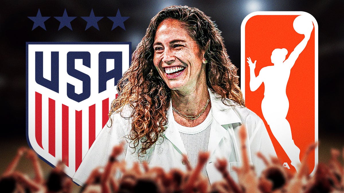 Storm's Sue Bird stands in front of US Women's Soccer, 2024 WNBA season logo