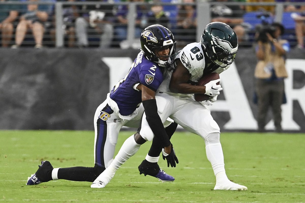  Philadelphia Eagles wide receiver John Ross (83) makes catch in front of Baltimore Ravens cornerback Nate Wiggins (2) during the first quarter of a preseason game at M&T Bank Stadium.