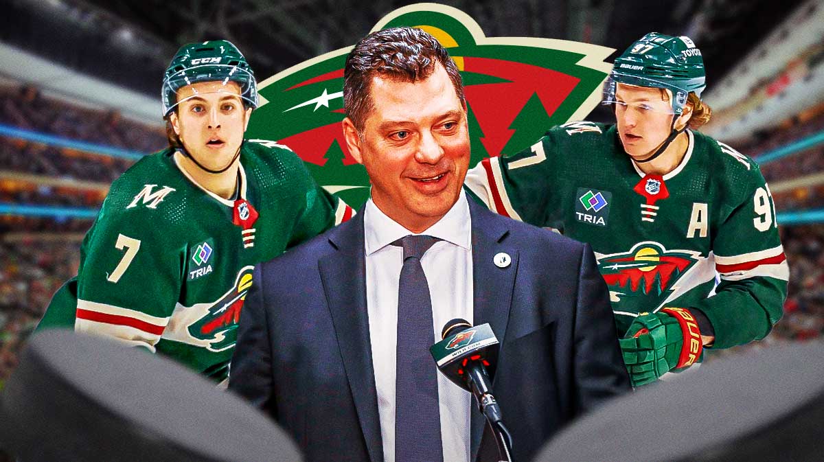 Bill Guerin in middle in a suit, Brock Faber and Kirill Kaprizov on either side, Minnesota Wild logo, hockey rink in background