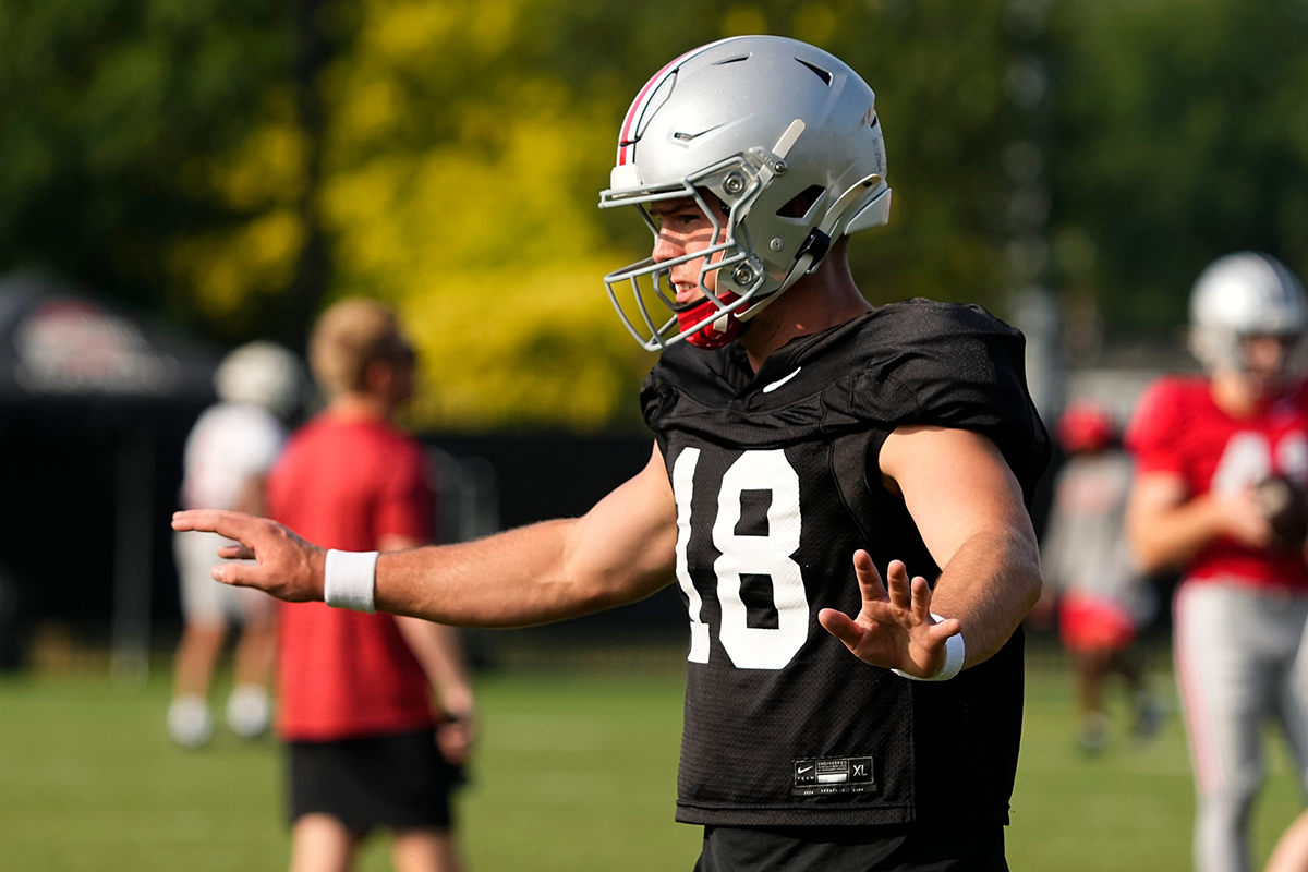 Aug 8, 2024; Columbus, Ohio, USA; Ohio State Buckeyes quarterback Will Howard (18) takes a snap during football practice at the Woody Hayes Athletic Complex.
