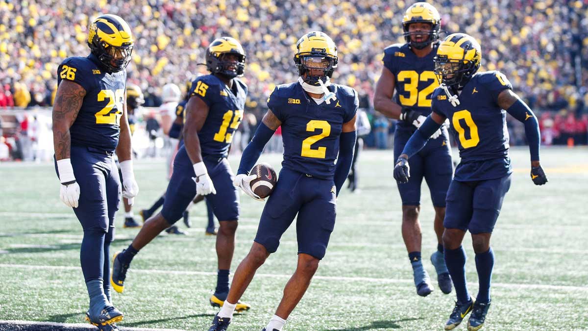 Michigan defensive back Will Johnson celebrates after intercepting a pass from Ohio State quarterback Kyle McCord during the first half at Michigan Stadium