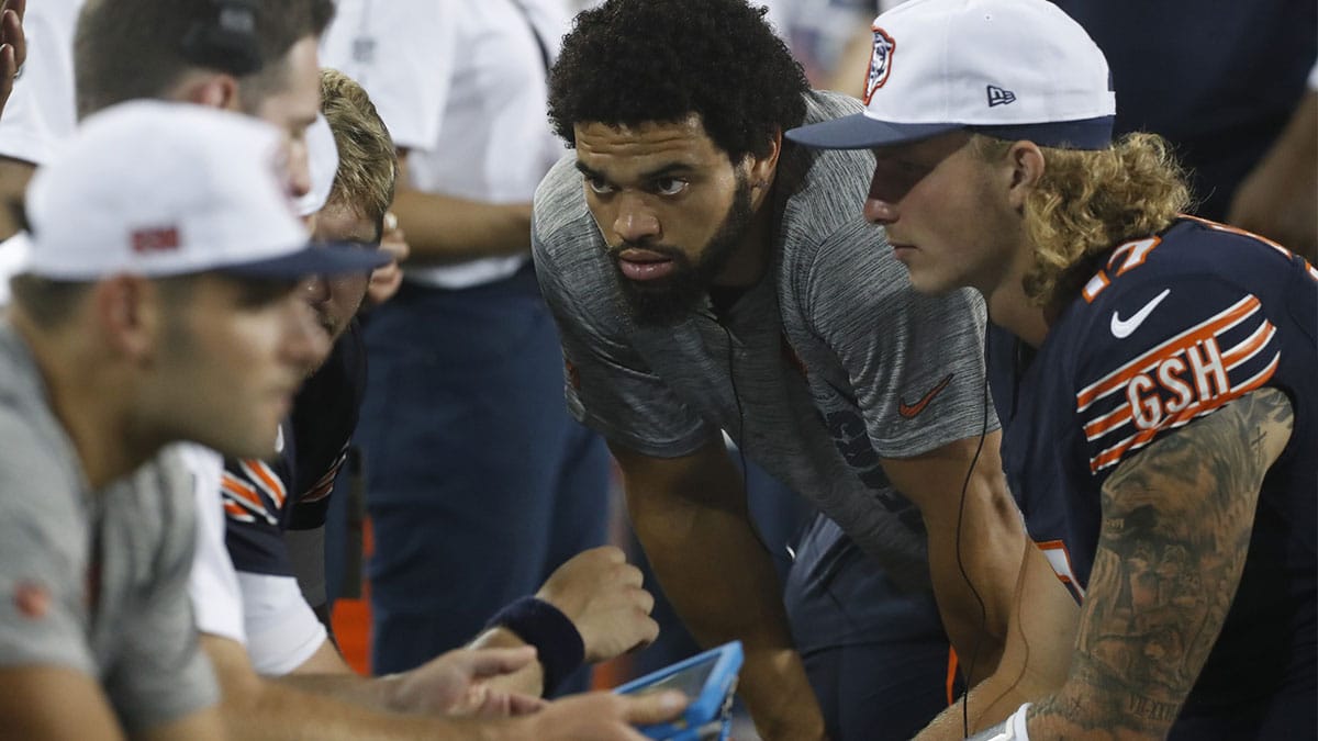 Chicago Bears quarterback Caleb Williams (RC) listens in the quarterback huddle on he sidelines against the Houston Texans during the third quarter at Tom Benson Hall of Fame Stadium.