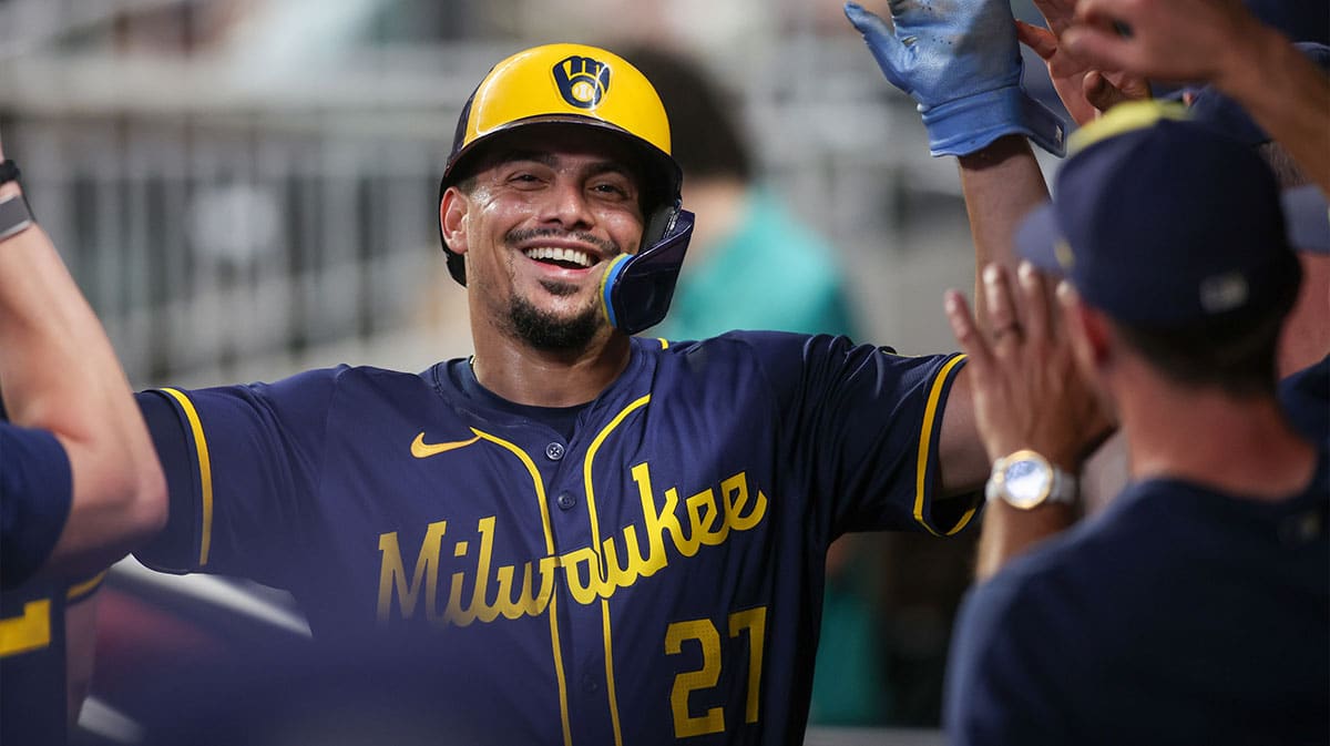 Milwaukee Brewers shortstop Willy Adames (27) celebrates with teammates after scoring a run against the Atlanta Braves in the eighth inning at Truist Park.