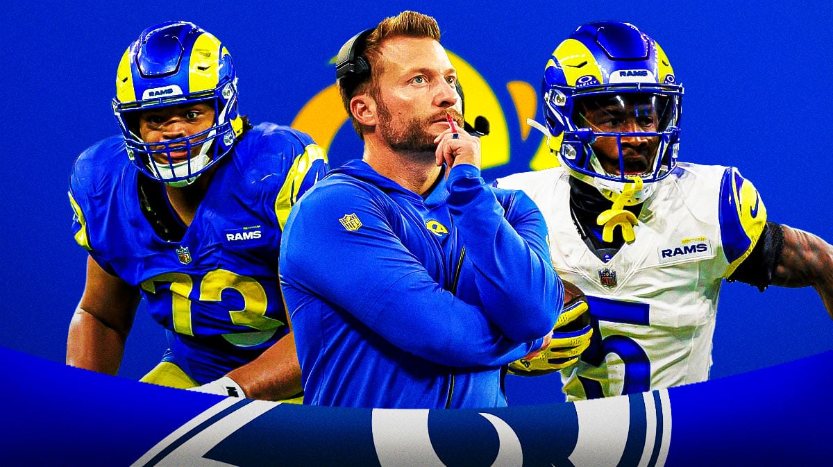 Coach Sean McVay in the middle, Steve Avila, Tutu Atwell around him, Los Angeles Rams wallpaper in the background